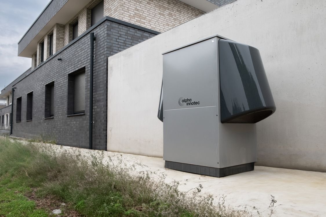 Air source heat pump installed outside a residential building illustrating home heating and climate control